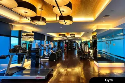 a gym with cardio equipment in a building at Spacious and Cozy 2 Br in The Gramercy Poblacion in Manila