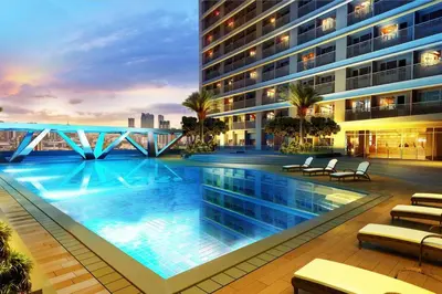 a swimming pool in the middle of a building at Cozy 2BR Unit in FAME Residences, Mandaluyong City in Manila