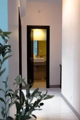 a bathroom with a sink and a mirror and a plant at Parksuites BGC - Spacious 2 Bedroom in Manila