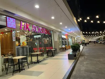 a restaurant with tables and chairs in a shopping mall at Shore 2 Family Suite 2 Beds Balcony City View WiFi Netflix MOA 735 in Manila