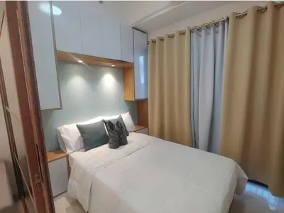 a bedroom with a white bed with shoes on it at Happy Haven at Lush Makati in Manila