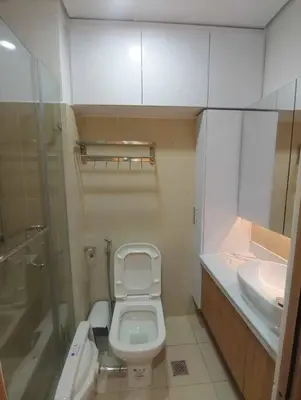 a small bathroom with a toilet and a sink at Happy Haven at Lush Makati in Manila