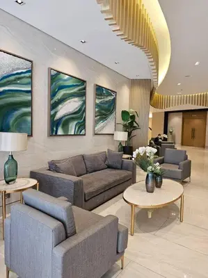 a living room with couches and tables and paintings at Alexa Smart Home l Balcony Night View l Fast Wifi in Manila