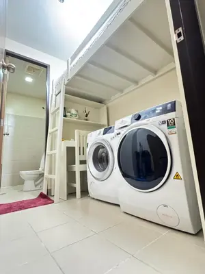 a washing machine in a room with a bathroom at Eastwood Global Plaza Luxury 1Bed Room with 2 Toilets and Laundry Room in Manila