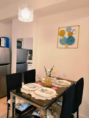 a dining room with a table with plates on it at CHILL City Escapes at Azure Urban Residences in Manila