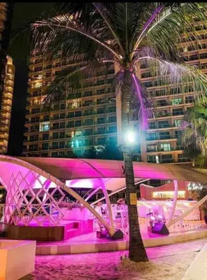 a bridge with a palm tree in front of a building at Azure Urban Residences Bahamas & One bedroom in Manila