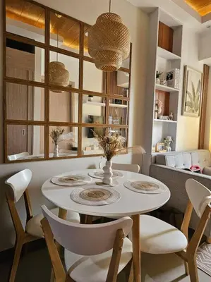 a dining room table with chairs and a white table and chairsktop at M Z Suite Home at SMDC Charm Residences in Manila