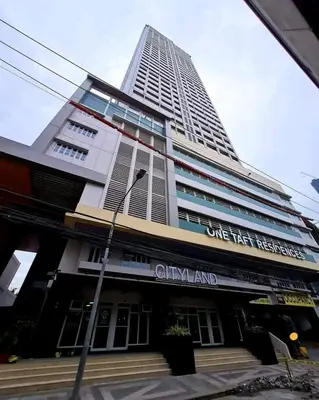 a tall building with a sign in front of it at One taft residence taft avenue City Land manila in Manila