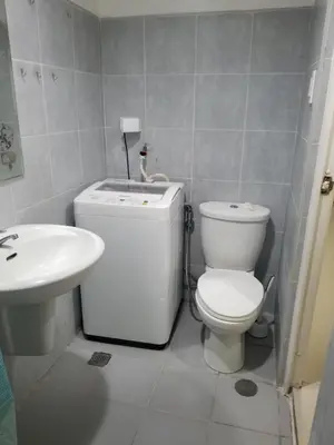 a bathroom with a toilet and a sink at Sea residence Family Group Affordable staycation in Manila