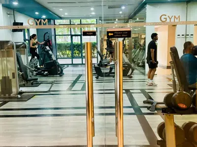 a gym with people exercising on tread machines at Enter Home McKinley with a View in Manila