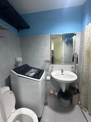 a bathroom with a toilet and a sink at Sea Residences Tower A 7th floor facing pool by Richnells your cozy oasis in Manila