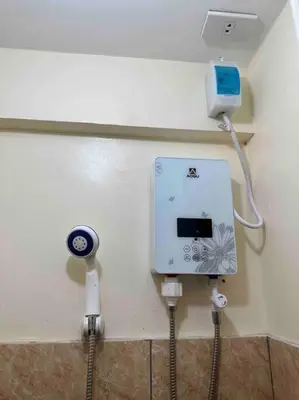 a room with a wall with a electrical outlet and a charger at Lawton Residences Studio Room 2J - 4 pax in Manila