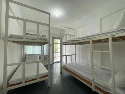 a room with three bunk beds and a window at Lawton Residences Studio Room 2J - 4 pax in Manila