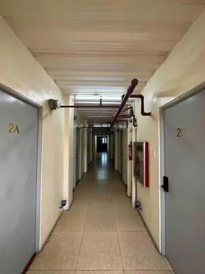 an empty hallway in a building with a long corridor at Lawton Residences Studio Room 3B - 4 pax in Manila
