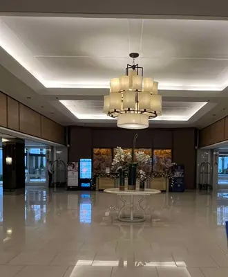 a large lobby with a table and a chandelier at Adrianne Condotel at Shell Residences Condominium, MOA Complex, Pasay City in Manila