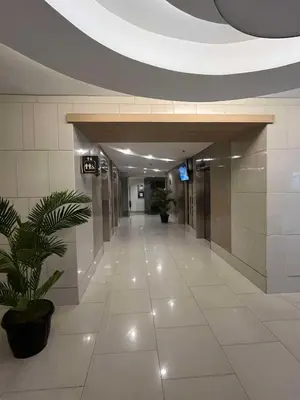 an empty hallway in a building with a plant at Adrianne Condotel at Shell Residences Condominium, MOA Complex, Pasay City in Manila