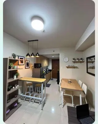 a kitchen and dining room with a table and chairs at Adrianne Condotel at Shell Residences Condominium, MOA Complex, Pasay City in Manila