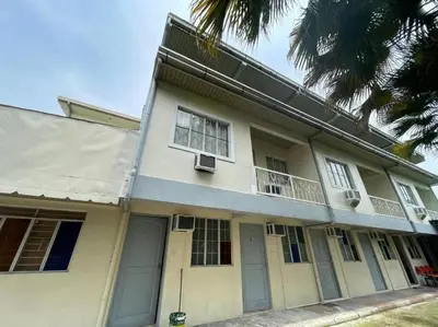 a white house with windows and a balcony at Lawton Residences Studio Room 3C - 4 pax in Manila