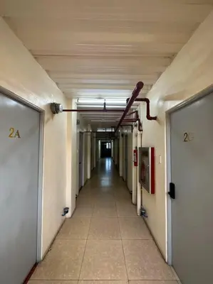 an empty hallway in a building with a long corridor at Lawton Residences Studio Room 3F - 4pax in Manila