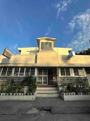 a large white building with a clock on top of it at Lawton Residences Studio Room 3F - 4pax in Manila