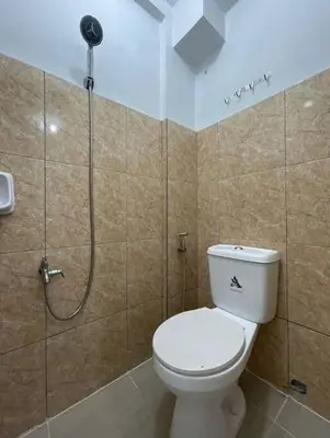 a bathroom with a toilet and a shower at Lawton Residences Studio Room 3J in Manila