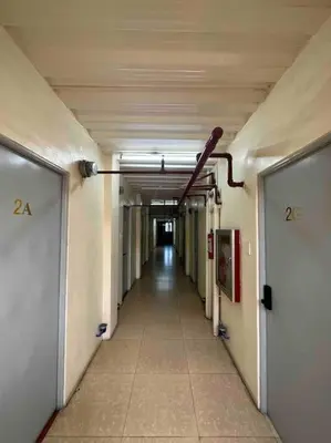 an empty hallway in an office building with a long corridor at Lawton Residences Studio Room 3J in Manila