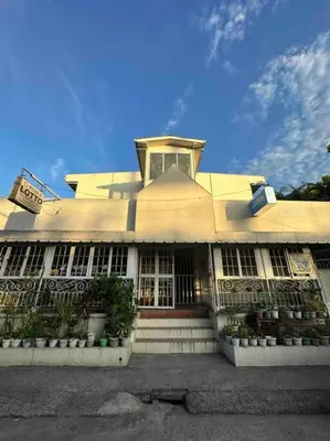 a large yellow building with a clock on top of it at Lawton Residences Studio Room 2D in Manila