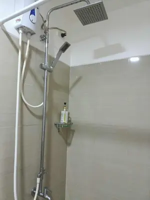 a shower in a bathroom with a shower head at Shore Residences - 1 Bedroom Condo Unit in Manila