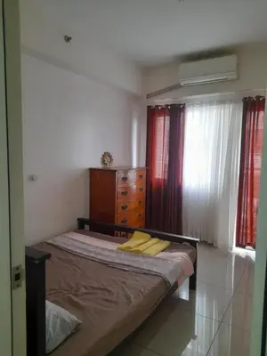 a bedroom with a bed and a dresser and windows at SMDC 2Bedroom SM Southmall in Manila