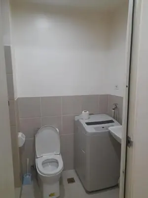 a small bathroom with a toilet and a sink at SMDC 2Bedroom SM Southmall in Manila