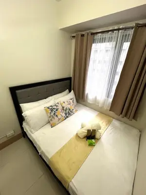 a bed with a teddy bear sitting on top of it at Sofias Haven - Shore 3 Residences T1 in Manila