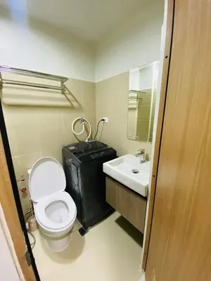 a bathroom with a white toilet and a sink at Sofias Haven - Shore 3 Residences T1 in Manila