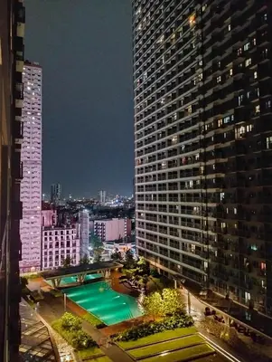 a view of a large building with a swimming pool at Ortigas Greenfield Cozy Lodge in Manila