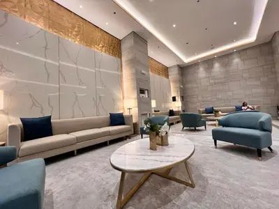 a lobby with couches and chairs and a table at Heart of Ortigas Center in Manila