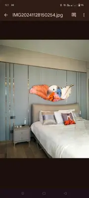 a bedroom with a bed with a bird on the wall at One Winstar Realty Corp in Manila