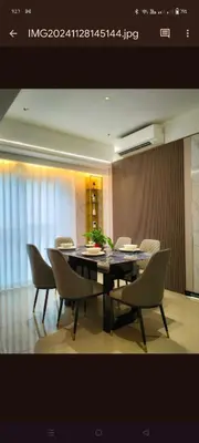 a dining room with a black table and chairs at One Winstar Realty Corp in Manila