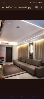a living room with a large couch in a room at One Winstar Realty Corp in Manila