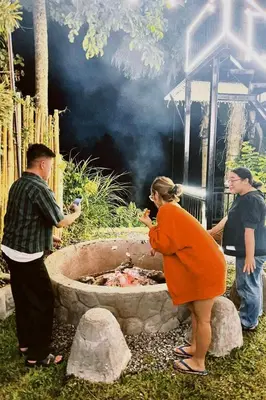a group of people standing around a fire pit at Villa Teodora in Biñan