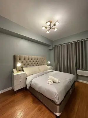 a bedroom with a bed and a ceiling fan at Best Deal! Cozy and Minimalist 2BR nr Airport in Manila