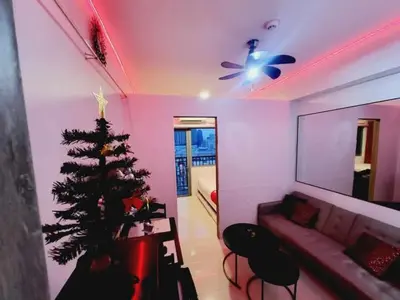 a living room with a christmas tree and a couch at Mavic Staycation in Manila