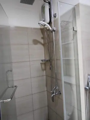 a shower with a glass door in a bathroom at Shore Residences - 1 Bedroom with Balcony in Manila
