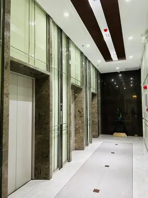 an empty hallway of a building with glass windows at HIGHLY RECOMMENDED La Nooq MNL - Cozy 1BR Skyline view in Mandaluyong in Manila