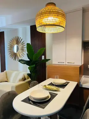 a living room with a table with plates on it at HIGHLY RECOMMENDED La Nooq MNL - Cozy 1BR Skyline view in Mandaluyong in Manila