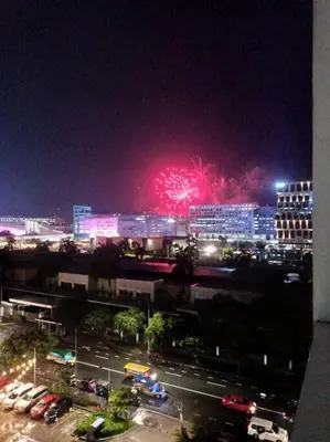 a fireworks display in a city at night at 1 Bedroom with Balcony Near MOA in Manila