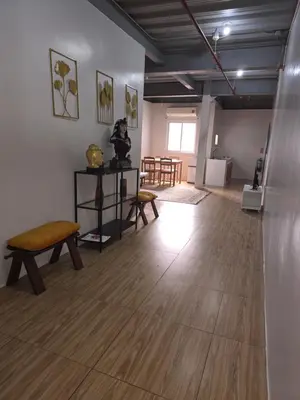 a room with a table and a bench and a room with chairs at 1 Bedroom Apartment in Central Makati in Manila
