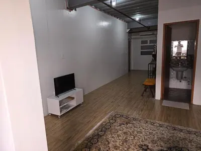 a living room with a flat screen tv on a stand at 1 Bedroom Apartment in Central Makati in Manila