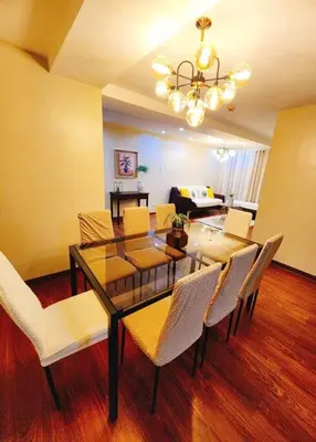a dining room with a glass table and chairs at 2BR 90sqm Furnished Condo Shaw Blvd, Mandaluyong in Manila