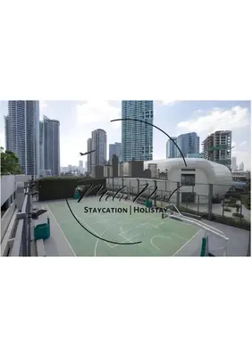 a tennis court in front of a city at MetroNest Dettifoss in Manila