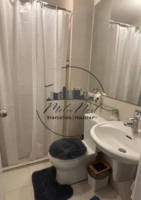 a bathroom with a shower and a toilet and a sink at MetroNest Dettifoss in Manila