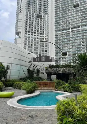 a swimming pool in a city with tall buildings at MetroNest Dettifoss in Manila